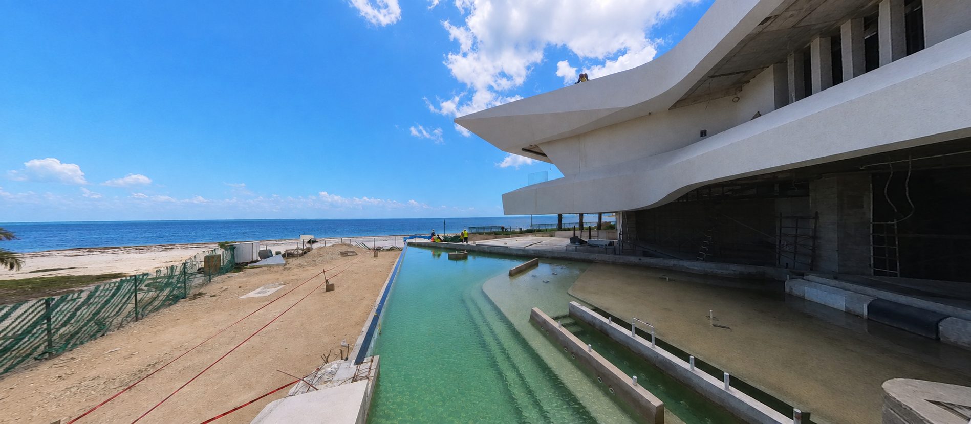 Dawn Villa — infinity pool construction progress with ocean views