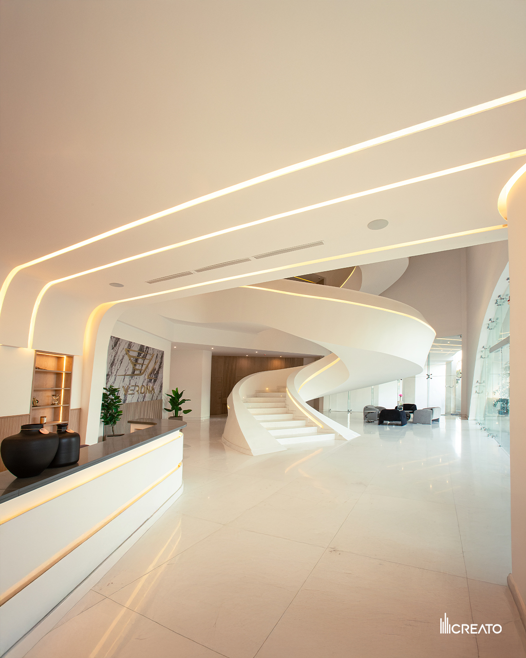 Verona Tower — lobby with sculptural white spiral staircase and reception desk