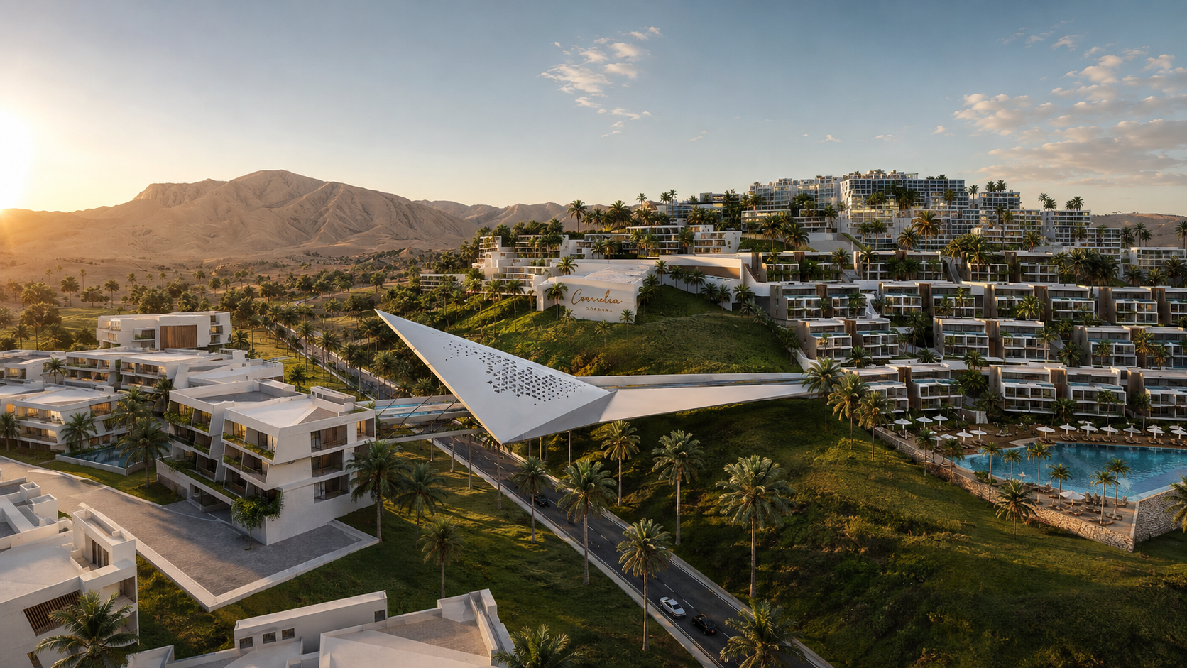 Carnelia — aerial view at sunset with the sculptural pedestrian bridge, residences, and lagoon pool